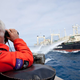 A Japanese “research” ship shoos away Sea Shepherd activists with water cannons while Paul Watson looks on. (Image: Sea Shepherd)
